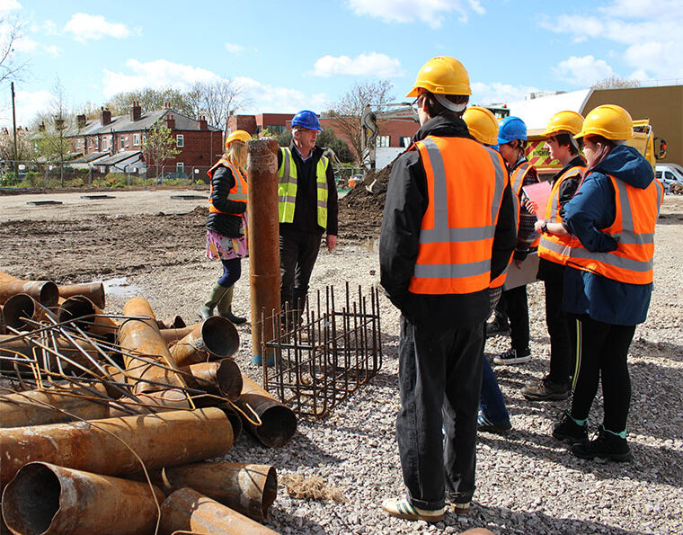 Photograph of Geology students visiting the site of the new college building.