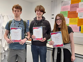 Another photograph of chemistry students collecting their Olympiad certificates.