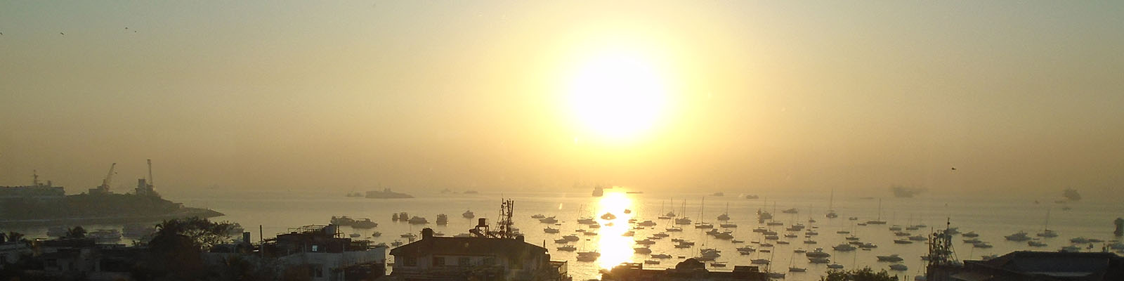 Photograph of sun setting over a harbour.