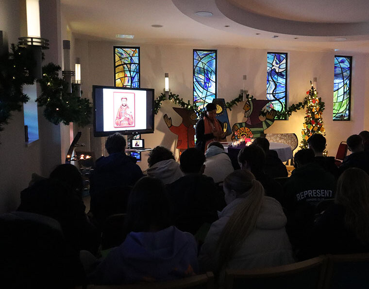 Photograph of a group of students attend chapel service in the chapel.