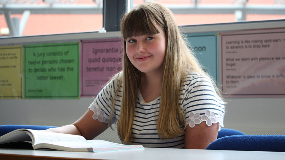 Photograph of an Applied Law student with an open book