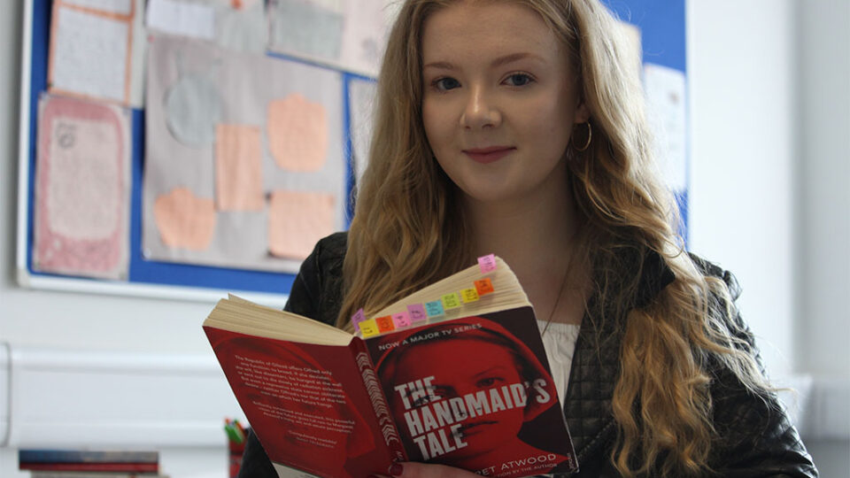 Photograph of a student studying the Handmaid's Tale