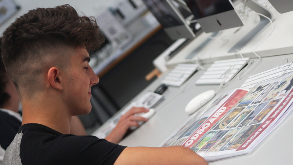 Photograph of a student working on a graphic design project