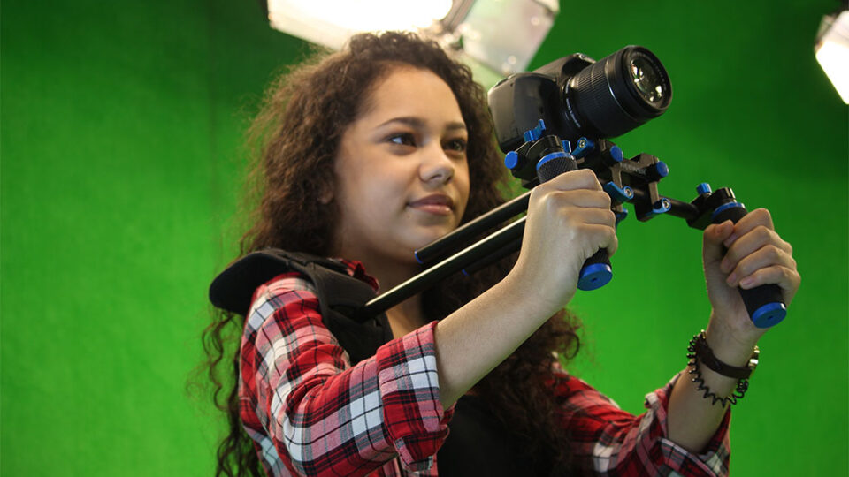 Photograph of a media student holding a handheld rig