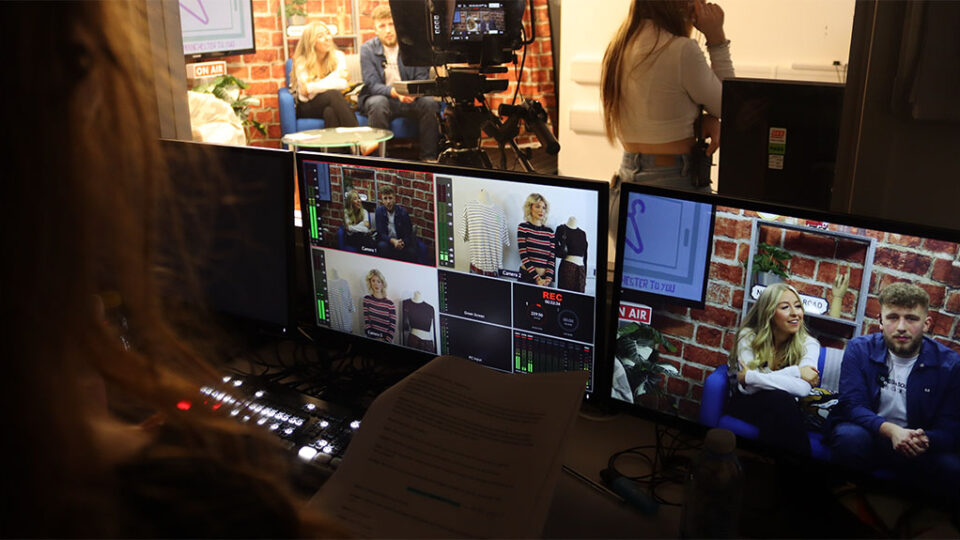 Photograph of students producing a mock live TV programme in the studio.