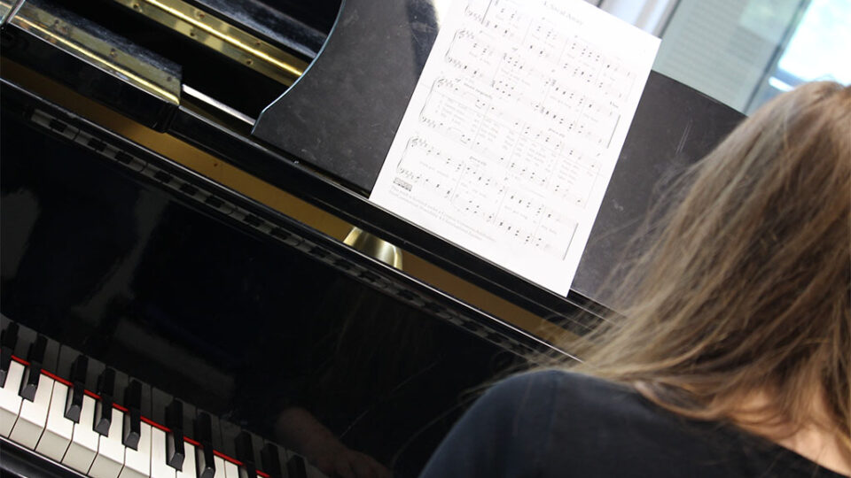 Photograph of a music student playing the piano