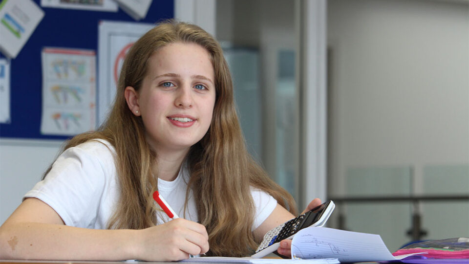 Photograph of a student with a calculator