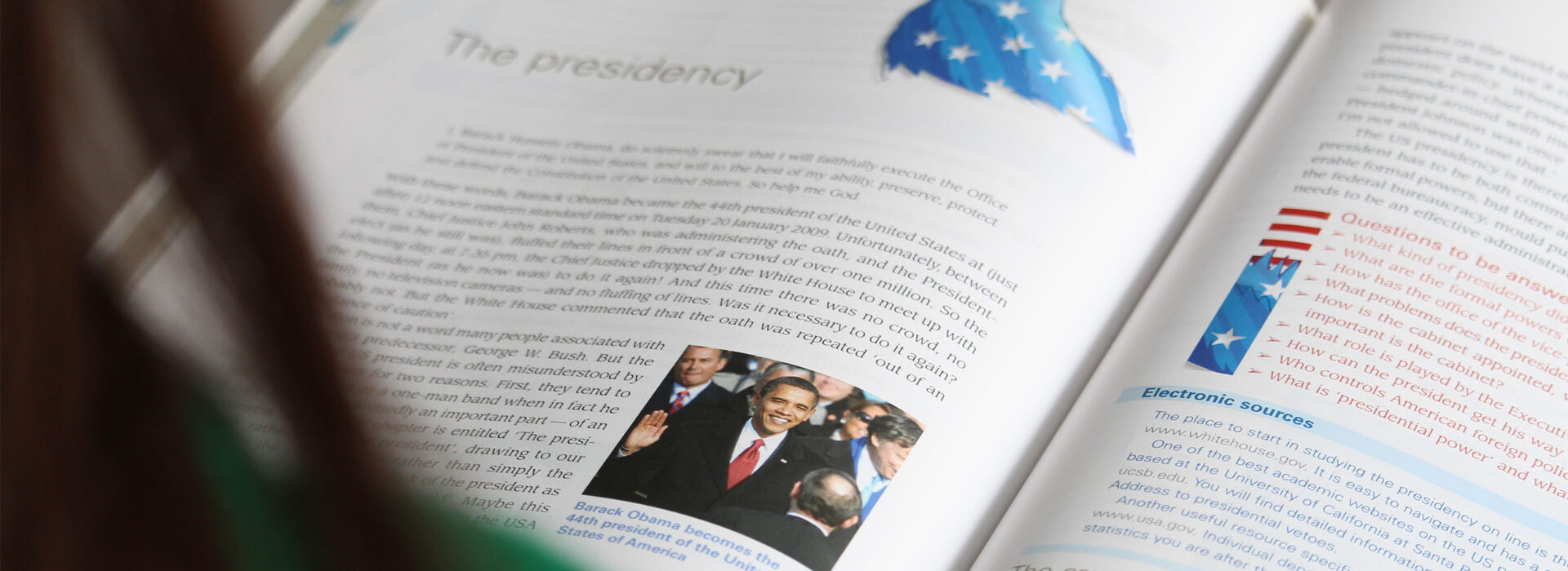 Photograph of a student reading a politics book.