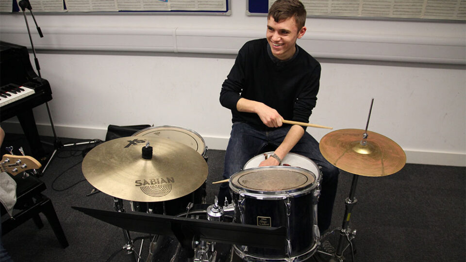 Photograph of a student playing the drums