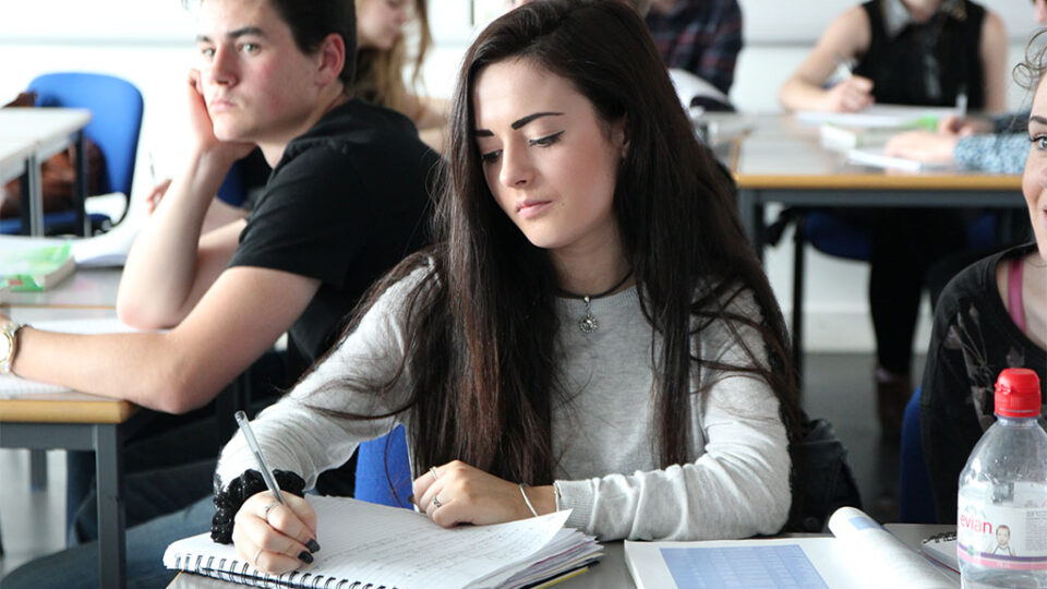 Photograph of a student studying in a classroom